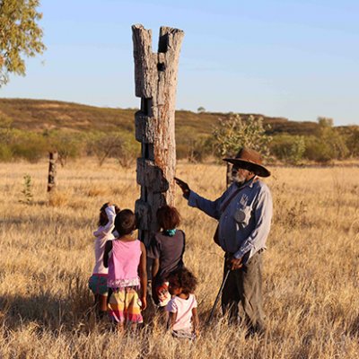 An indigenous man speaking to his grandchildren